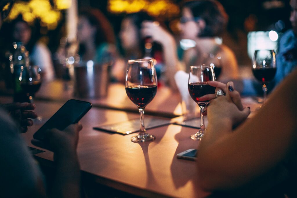A social gathering with people enjoying wine glasses in an evening setting.